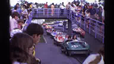Orlando Florida (1974): A Line Of Bumper Cars Surrounded By People Standing On A