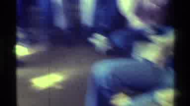 Kentucky (1976): Man Wearing Blue Shirt Sits In Tan Chair Watching Television