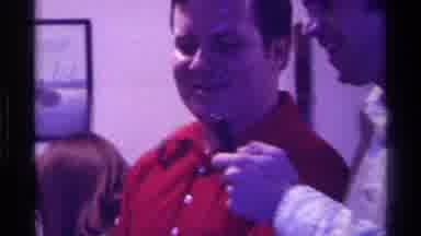 Kentucky (1976): Man With Microphone Talks To Man In Red Shirt And Seated Woman