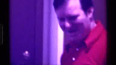 Kentucky (1976): Man In Red Polo Shirt Talking To A Friend And Laughing