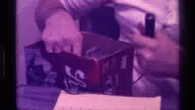 Kentucky (1976): Man Talks To The Camera And Points At The Box In His Lap