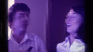 Kentucky (1976): Woman Wearing White Shirt Points To A Small Black Microphone