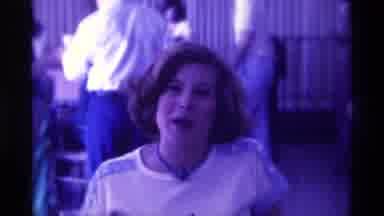 Kentucky (1976): Woman Talks To The Camera While Using A Small Mic As Others Stand