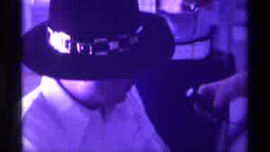 Kentucky (1976): A Man Wearing A Funny Hat And With A White Skirt Is Being