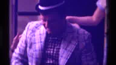 Kentucky (1976): Man Wearing Small Black Hat Its Back In Tan Chair