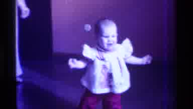 Kentucky (1976): Toddler Wearing Red Pants Walks Toward Camera On A Sunny Day