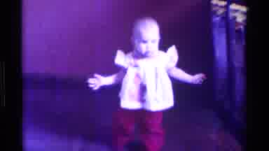 Kentucky (1976): A Baby In A Frilly Shirt And Red Pants Walking Towards The Camera