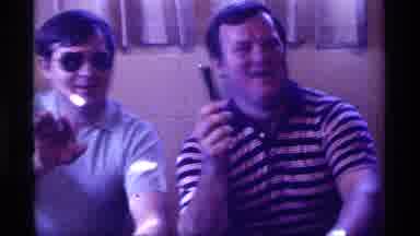 Kentucky (1976): Man Wearing Striped Shirt And Holding Black Microphone Stands Up