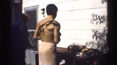 California (1978): Men Outdoors Cook Food On Barbecue During Party Or Other