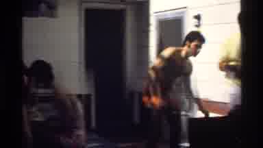 California (1978): Men And Women Eat Meal Outdoors At Barbecue In Swimwear In