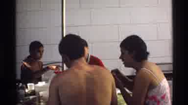 California (1978): Man With White Towel Around Neck Walks Out Of Building On A