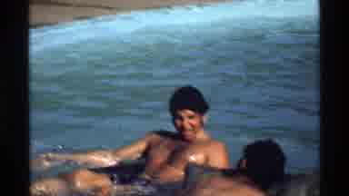 California (1978): Men On Inflatable Rafts Paddle Out Into The Ocean On A Sunny