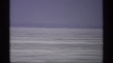 Madison Wisconsin (1966): View Of Frozen Field And Brown Building On A Cloudy Day