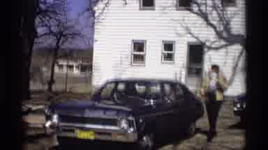 Madison Wisconsin (1966): Man Puts On A White Hat And Gets Into His Blue Car