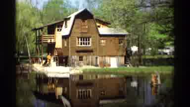 Holland Michigan (1969): Large Brown House With Watermill Over Water In Green Area