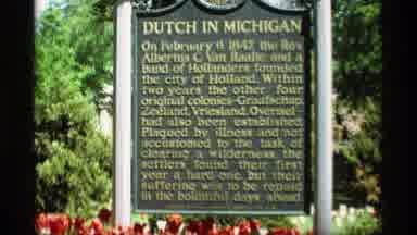 Holland Michigan (1969): Their Is A Man That Reading The Dutch In Michigan Sign