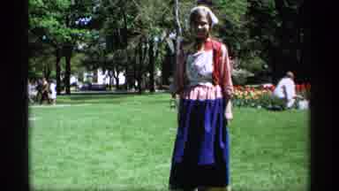 Holland Michigan (1969): A Woman Standing In Old-Fashioned Clothing Stands Near A