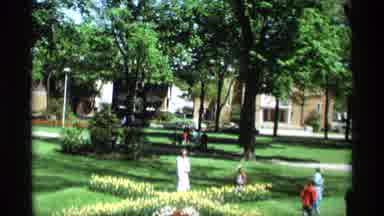 Holland Michigan (1969): People In A Park While The Sun Is Shining And Flowers Are