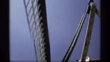Holland Michigan (1969): Giant Windmill Blades Turn Under A Blue Sky Followed By