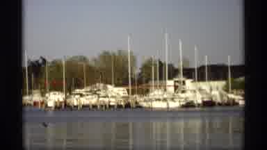 Holland Michigan (1969): White Boats Sit Motionless On Wide Lake During Summertime