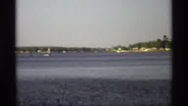 Holland Michigan (1969): A View Of Sailboats From Far Away With A Clear Blue Ocean