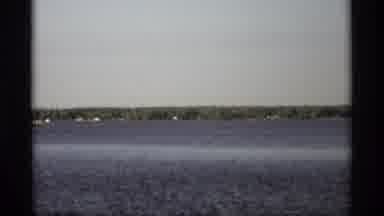 Holland Michigan (1969): A Large Body Of Water Possibly River With Trees In The