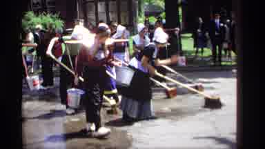 Holland Michigan (1969): Women Wearing Traditional Garments Cleaning A Street With