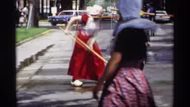 Holland Michigan (1969): People In Costume Cleaning Street With Broom And Water