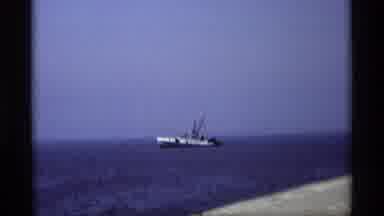 Holland Michigan (1969): People In A Car Watching A Large Boat In The Open Ocean