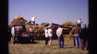 Jordan Minnesota (1969): Two People Pitching Hay For Incinerator On A Sunny Day