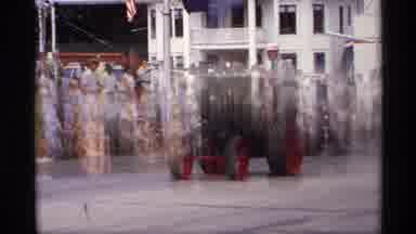 Mabel Minnesota (1969): Man Wearing Blue Shirt Drives Steam Tractor Down Street In