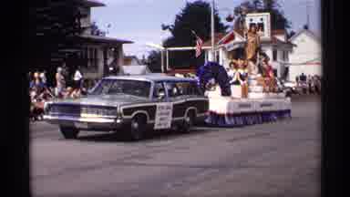 Mabel Minnesota (1969): Car With A Parade Float Rides Through Streets Of Small