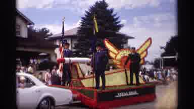 Mabel Minnesota (1969): A Blue Car And A White Car Are Transportation Carts With