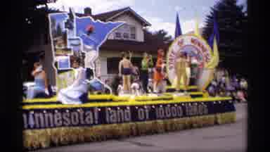Mabel Minnesota (1969): Floats Move Down City Street In Community Parade Tri