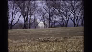 Savage Minnesota (1969): Video Of Gray Brown Field In Background With Dead Trees