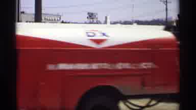 Savage Minnesota (1969): Red Truck Passes By Two Men Standing On Corner On A Sunny