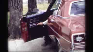 Savage Minnesota (1969): A Man Exits His Large Sedan As He Arrives Home With His