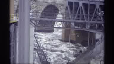 Savage Minnesota (1969): A Strong River In Front Of Some Constructions And Below A