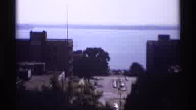 Wisconsin (1969): This A Roof Top View Of A Big City Surrounded By A Large Body Of