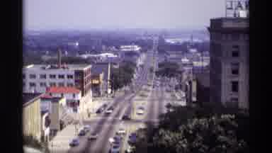 Wisconsin (1969): Long City Road Street New Tall Buildings Cars Running Down The