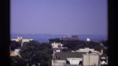 Wisconsin (1969): High Angle Of Buildings In City With Trees And Water Visible In