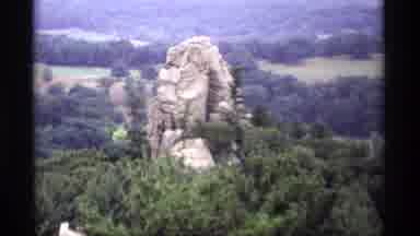 Wisconsin (1969): A Large Rock Outcrop In A Forest Cuts To A Waterwheel Men In