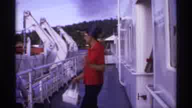 Canada-1974: Woman Walking on Ferry Deck with Vintage Cars at Dock