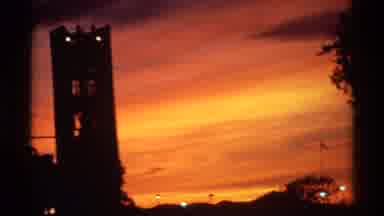 Canada (1974): View Of Illuminated Towers Against Fiery Orange Sunset On Clear Day