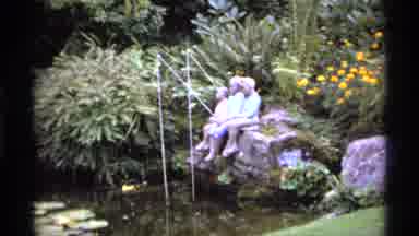 Vancouver Canada (1974): Three Kids Sit On Rocks Two With Fishing Poles On A Clear