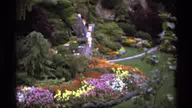 Vancouver Canada (1974): People Walking Down A Stone Path Through A Flower Garden