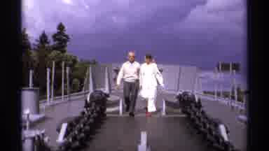 Vancouver Canada (1974): White Couple Holding Hands Cross Bridge In The Wind