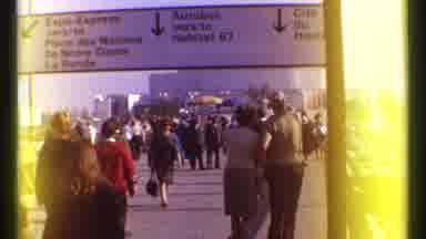 Montreal Canada (1967): People Walk On Plaza Underneath Sign Showing Directions To