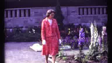 Montreal Canada (1967): Woman In Red Pattern Dress Walks In Flower Garden Then