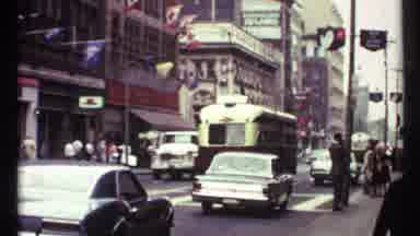 Toronto Canada (1967): Tram And Cars On Street Pans To Seal With Flags With People
